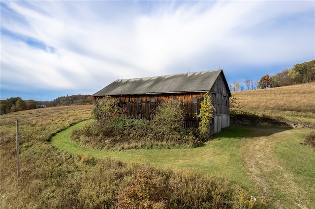 view of outdoor structure with a rural view