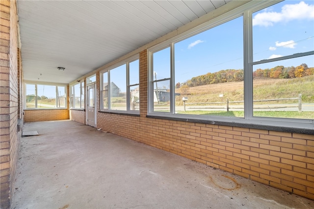 unfurnished sunroom with a rural view and plenty of natural light