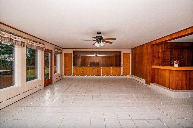 interior space with ceiling fan and baseboard heating