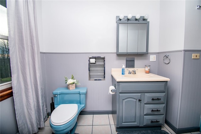 bathroom featuring tile patterned flooring, vanity, and toilet