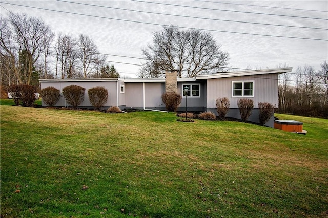 132 Random Rd, Corry, PA 16407 - view of front of home with a hot tub, a front yard, and a chimney