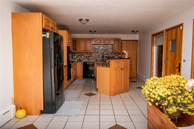 kitchen featuring a center island, baseboard heating, decorative backsplash, light tile patterned floors, and black appliances