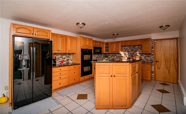 kitchen featuring a center island, black appliances, decorative backsplash, a textured ceiling, and light tile patterned flooring