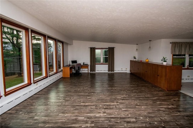 132 Random Rd, Corry, PA 16407 - unfurnished living room with a textured ceiling, a baseboard radiator, wood finished floors, and plenty of natural light