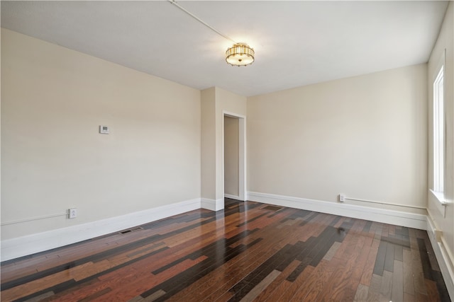 spare room featuring dark hardwood / wood-style floors