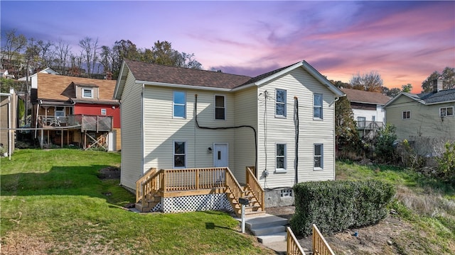 view of front of property featuring a wooden deck and a lawn