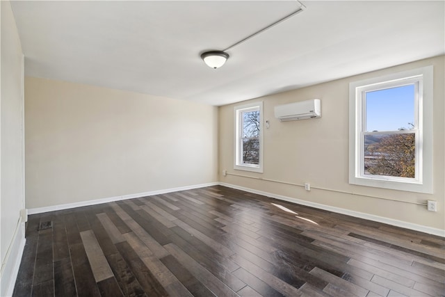 unfurnished room with dark hardwood / wood-style floors and a wall mounted AC