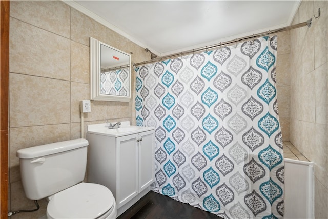 bathroom featuring crown molding, vanity, tile walls, and toilet