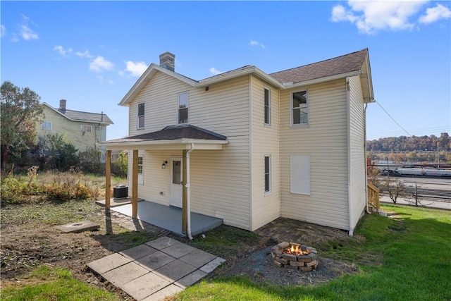 rear view of house featuring a yard and central air condition unit