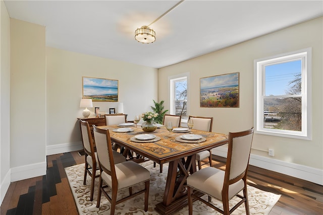 dining space with dark hardwood / wood-style floors