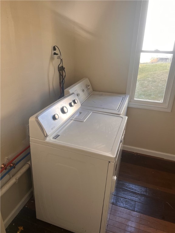 laundry room featuring washing machine and dryer and dark hardwood / wood-style floors