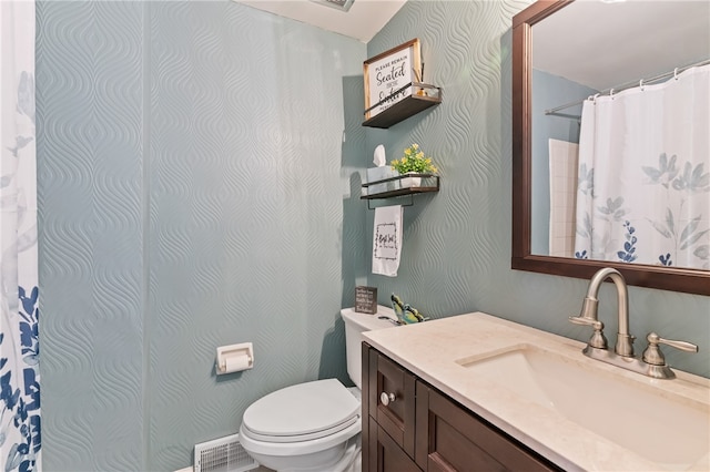 bathroom featuring toilet and vanity