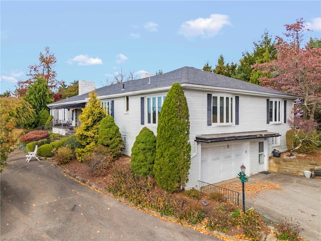 view of side of home featuring a garage