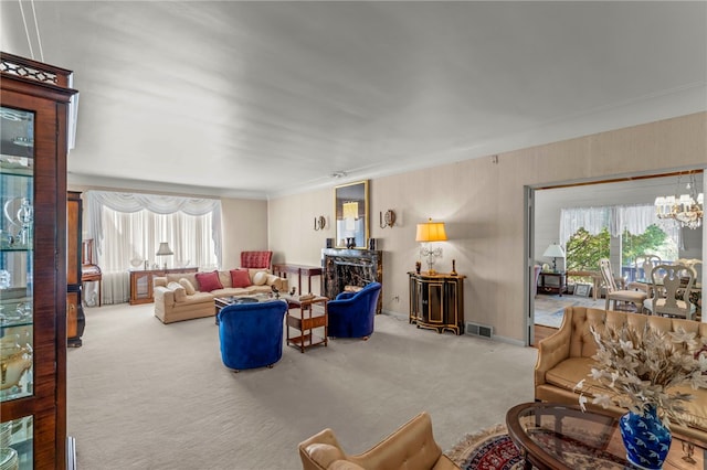 carpeted living room featuring a chandelier