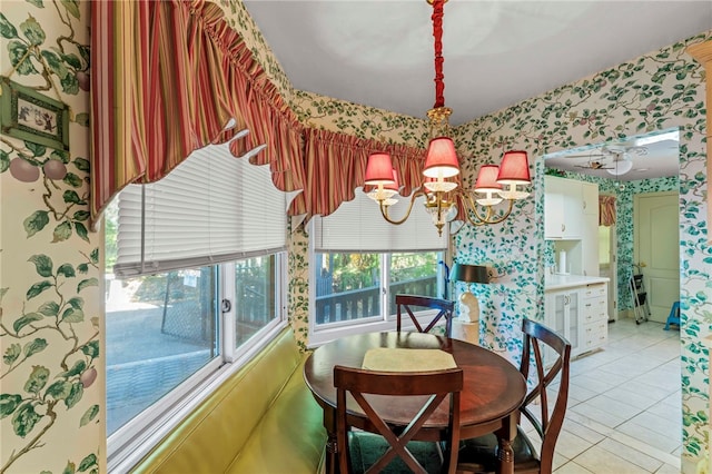 dining space featuring a healthy amount of sunlight, an inviting chandelier, and light tile patterned flooring