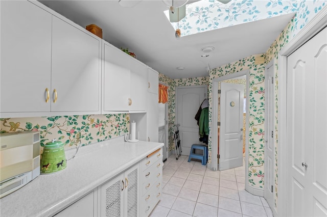 kitchen featuring white cabinetry and light tile patterned floors