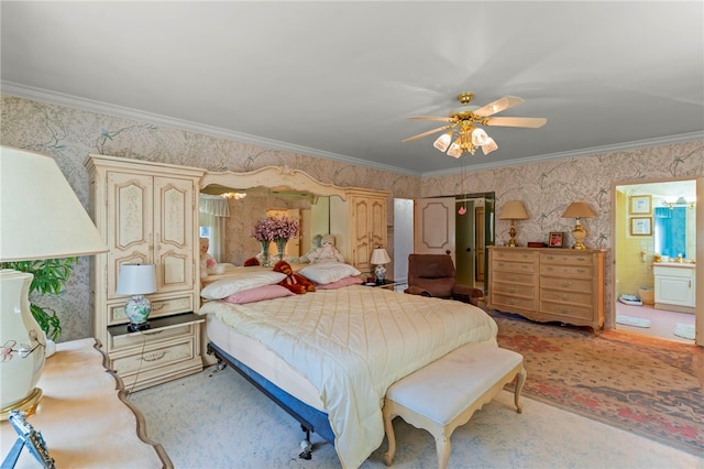 bedroom with ceiling fan, crown molding, and ensuite bathroom