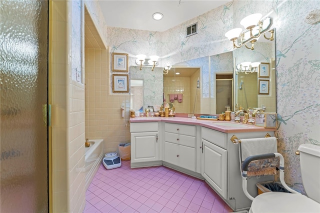 full bathroom featuring shower with separate bathtub, toilet, tile patterned floors, tile walls, and vanity