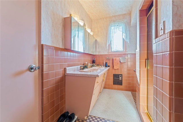 bathroom featuring vanity, tile walls, and heating unit