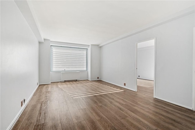 320 Fort Duquesne Blvd Unit 11-O, Downtown Pgh, PA 15222 - unfurnished room with wood finished floors, radiator heating unit, and baseboards