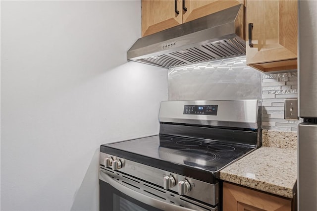 320 Fort Duquesne Blvd Unit 11-O, Downtown Pgh, PA 15222 - kitchen with stainless steel range with electric stovetop, under cabinet range hood, tasteful backsplash, and light stone counters