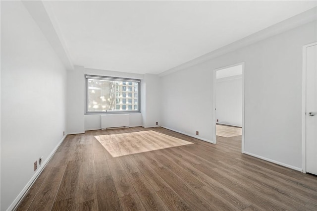 320 Fort Duquesne Blvd Unit 11-O, Downtown Pgh, PA 15222 - spare room featuring radiator, wood finished floors, and baseboards