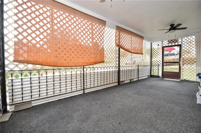 unfurnished sunroom featuring ceiling fan