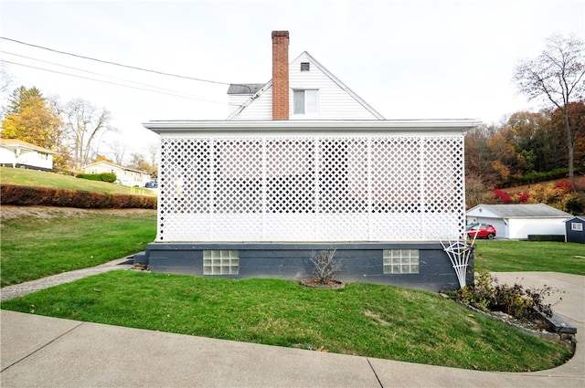 view of property exterior with a lawn