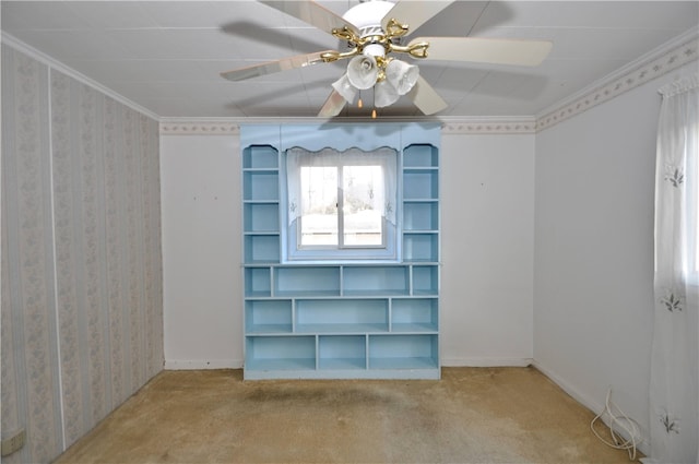 carpeted empty room featuring ceiling fan and ornamental molding