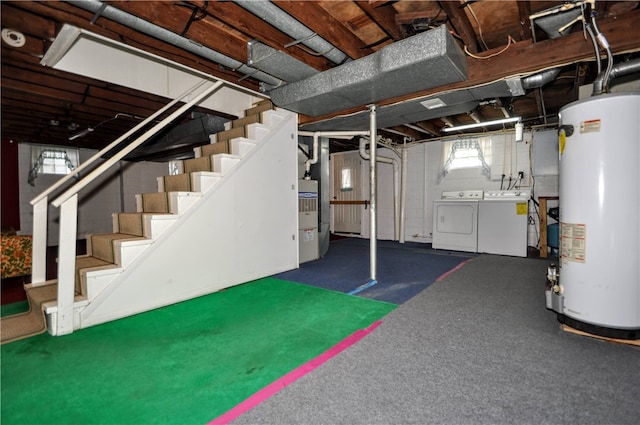 basement with dark carpet, gas water heater, and separate washer and dryer