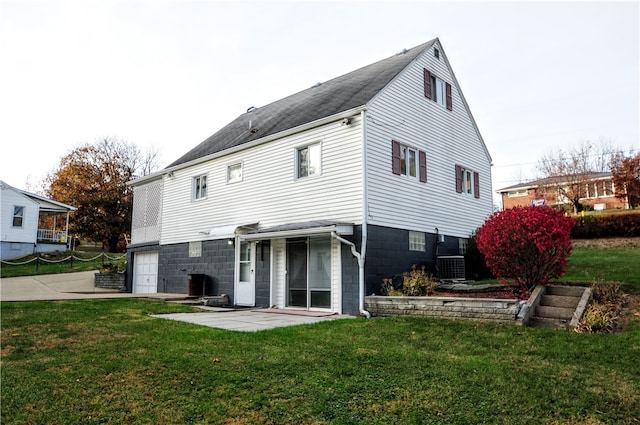 back of house featuring a patio and a lawn