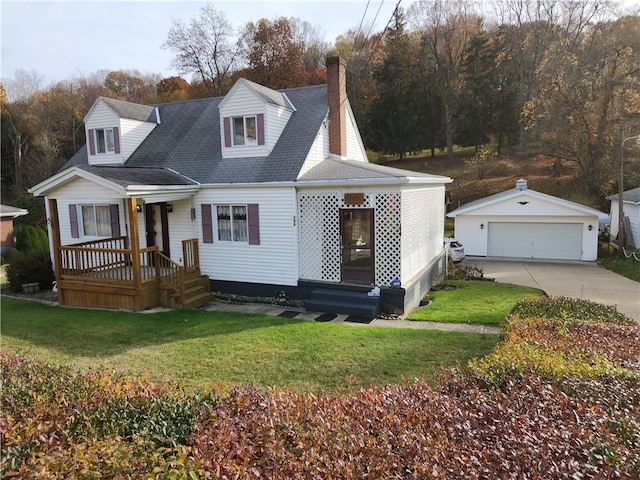 view of front of house with a front yard, an outbuilding, and a garage