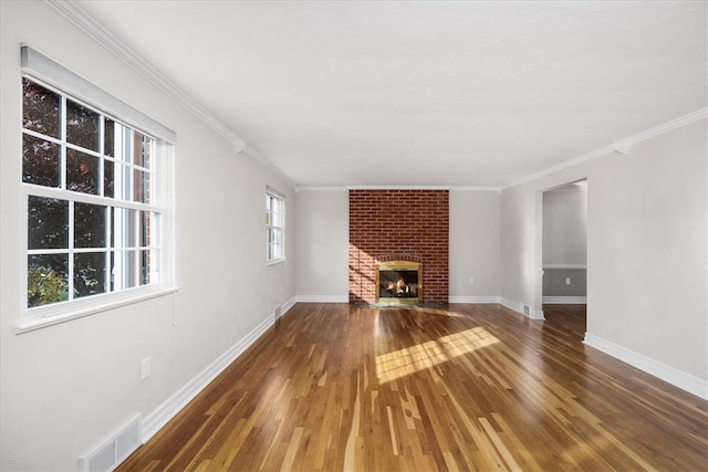 unfurnished living room featuring crown molding, dark wood-type flooring, and a fireplace