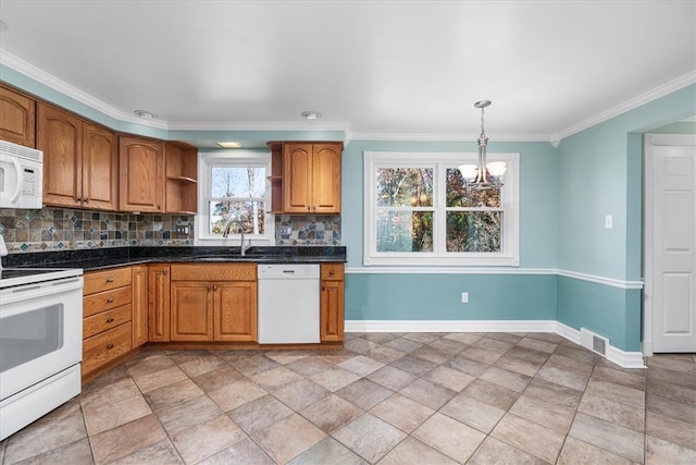 kitchen with sink, decorative light fixtures, an inviting chandelier, white appliances, and tasteful backsplash