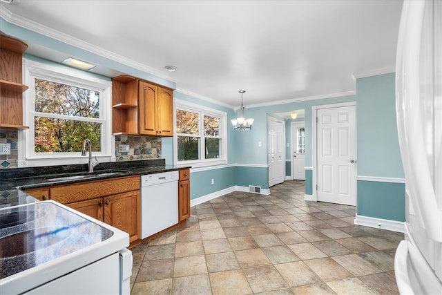 kitchen with a wealth of natural light, sink, decorative backsplash, and white appliances