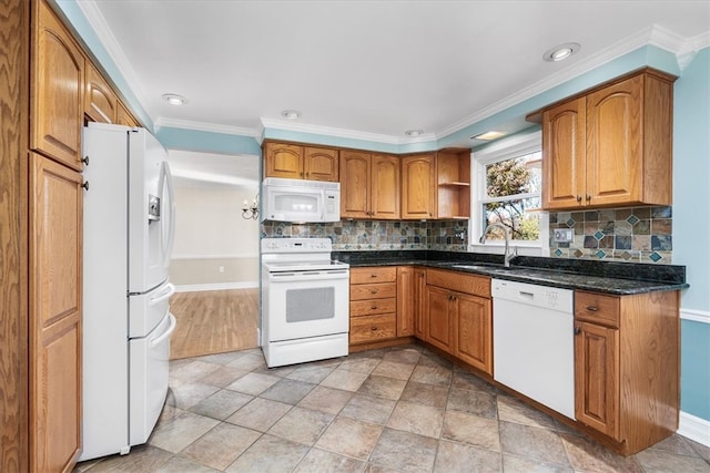 kitchen with backsplash, crown molding, white appliances, and dark stone countertops