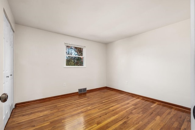 spare room with hardwood / wood-style flooring