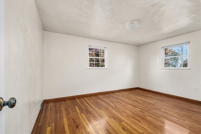 unfurnished room featuring wood-type flooring and a wealth of natural light