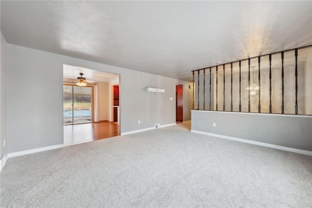 carpeted spare room featuring ceiling fan