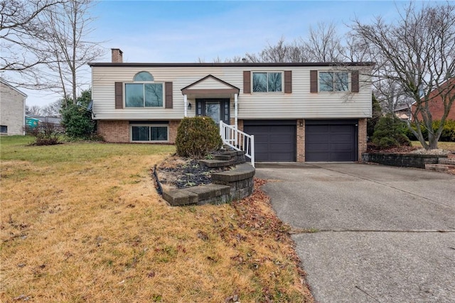 bi-level home with a front yard and a garage