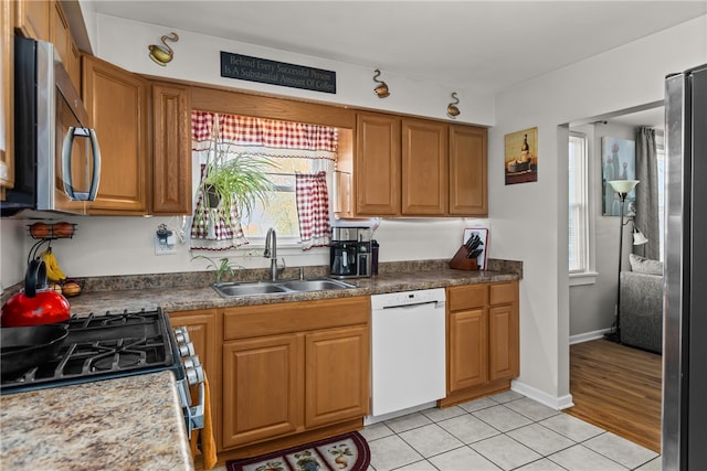 kitchen featuring light hardwood / wood-style floors, appliances with stainless steel finishes, and sink