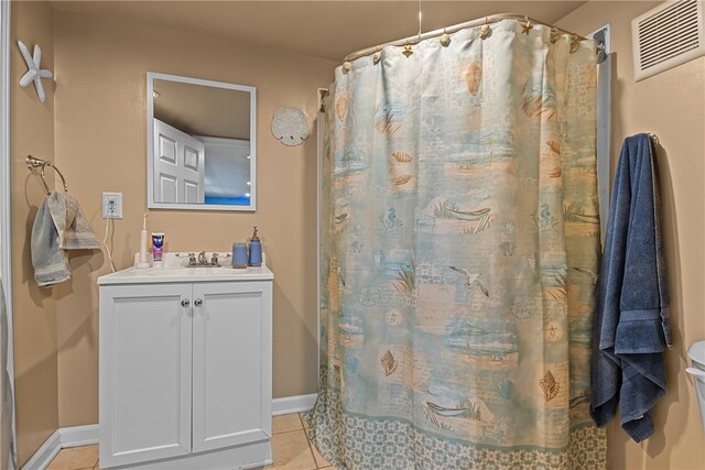 bathroom with walk in shower, tile patterned flooring, and vanity