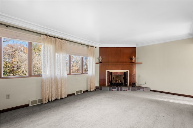 unfurnished living room featuring a fireplace, ornamental molding, and carpet floors