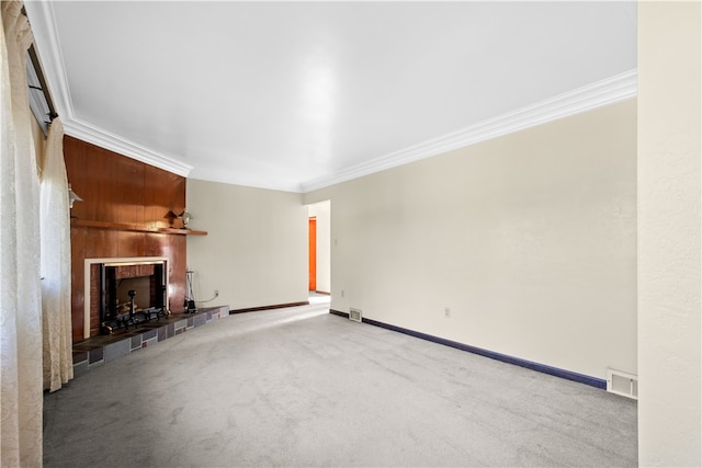 unfurnished living room featuring a fireplace, carpet flooring, and crown molding