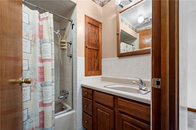 bathroom with tile walls, vanity, and shower / bath combo with shower curtain