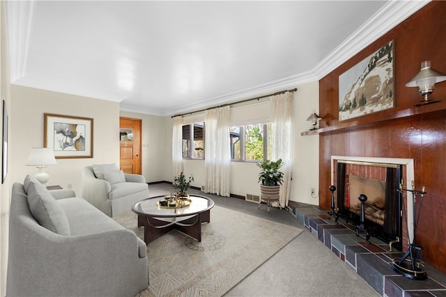 carpeted living room with a tile fireplace and ornamental molding