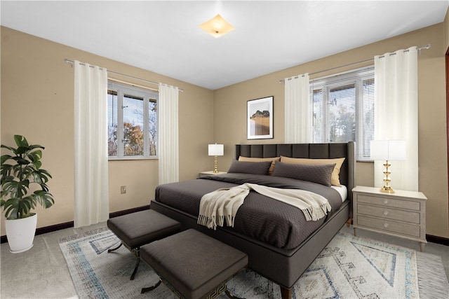 carpeted bedroom featuring multiple windows