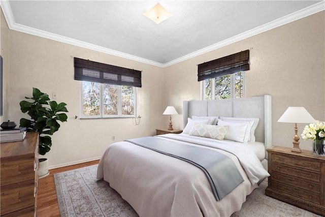 bedroom featuring hardwood / wood-style flooring and ornamental molding