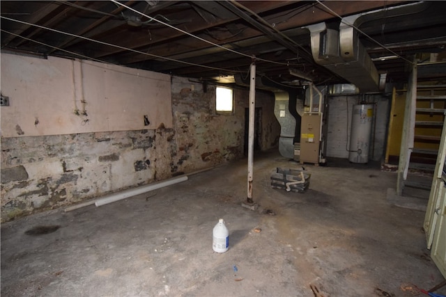 basement featuring gas water heater and heating unit