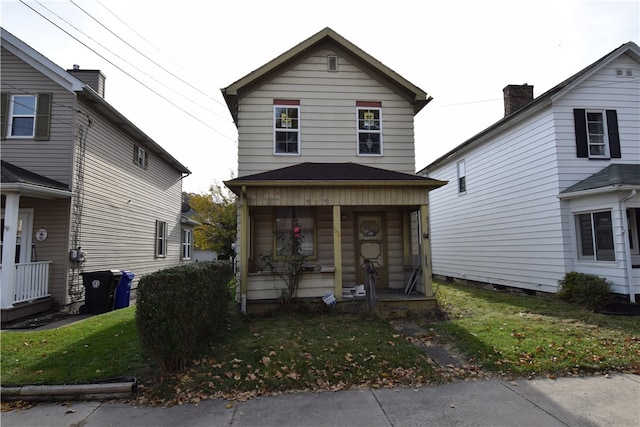 front of property featuring a porch and a front lawn